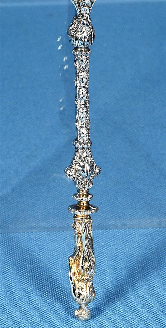 A cased set of four Victorian silver parcel gilt fruit serving spoons and a sugar sifter, spoon 197mm, weight 12.4oz/388 grms.